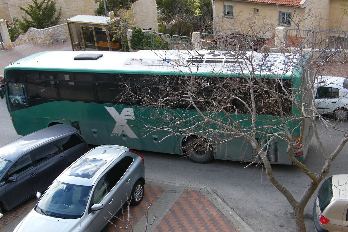 An intercity bus on a residential street in Efrat