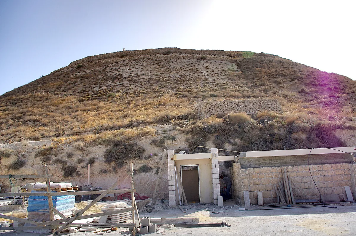 The cone-shaped hill of the Herodium seen from its base, with the entrance buildings in front