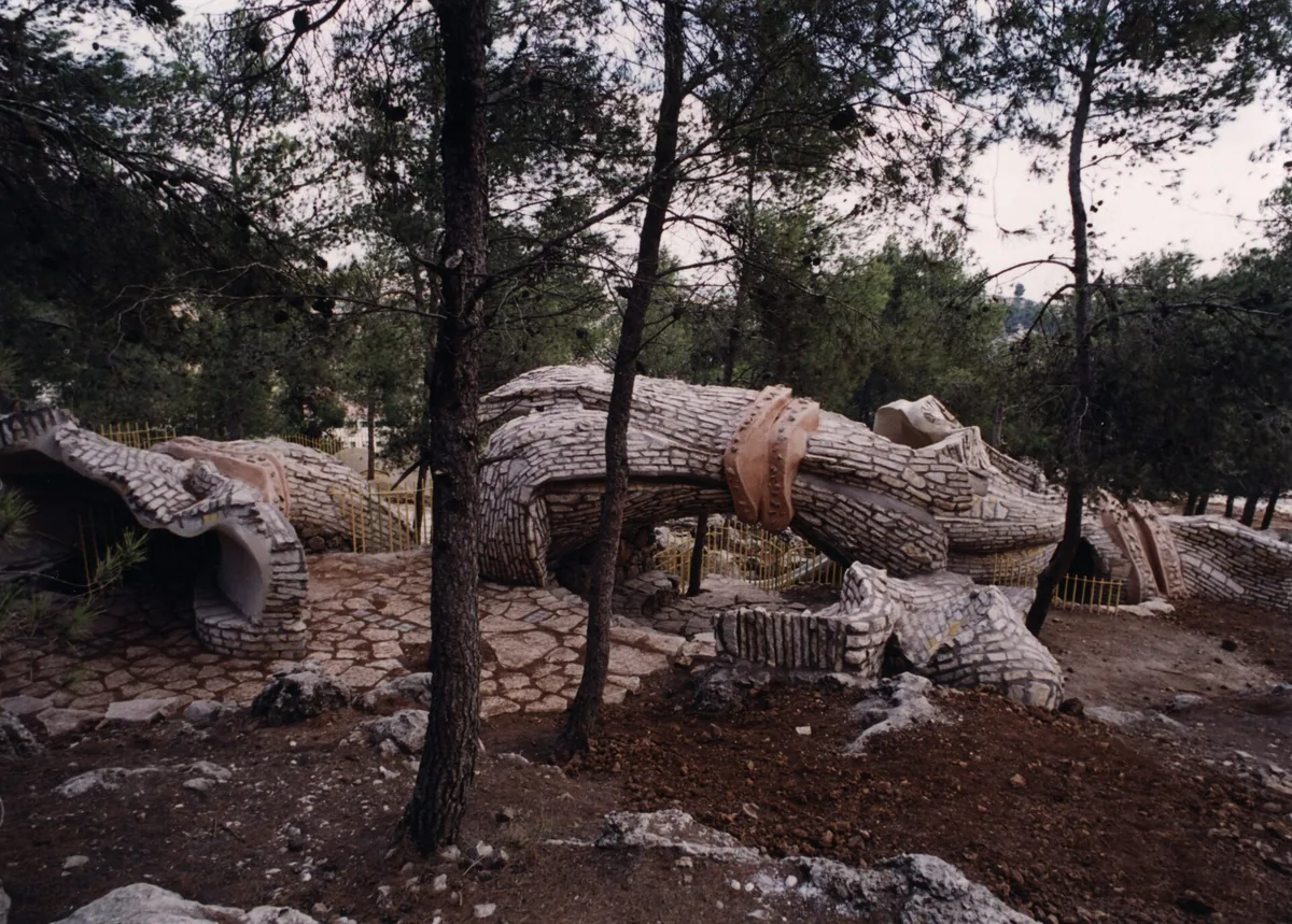 The Whispering Stalks environmental sculpture in Efrat: large stone and metal forms among pine trees